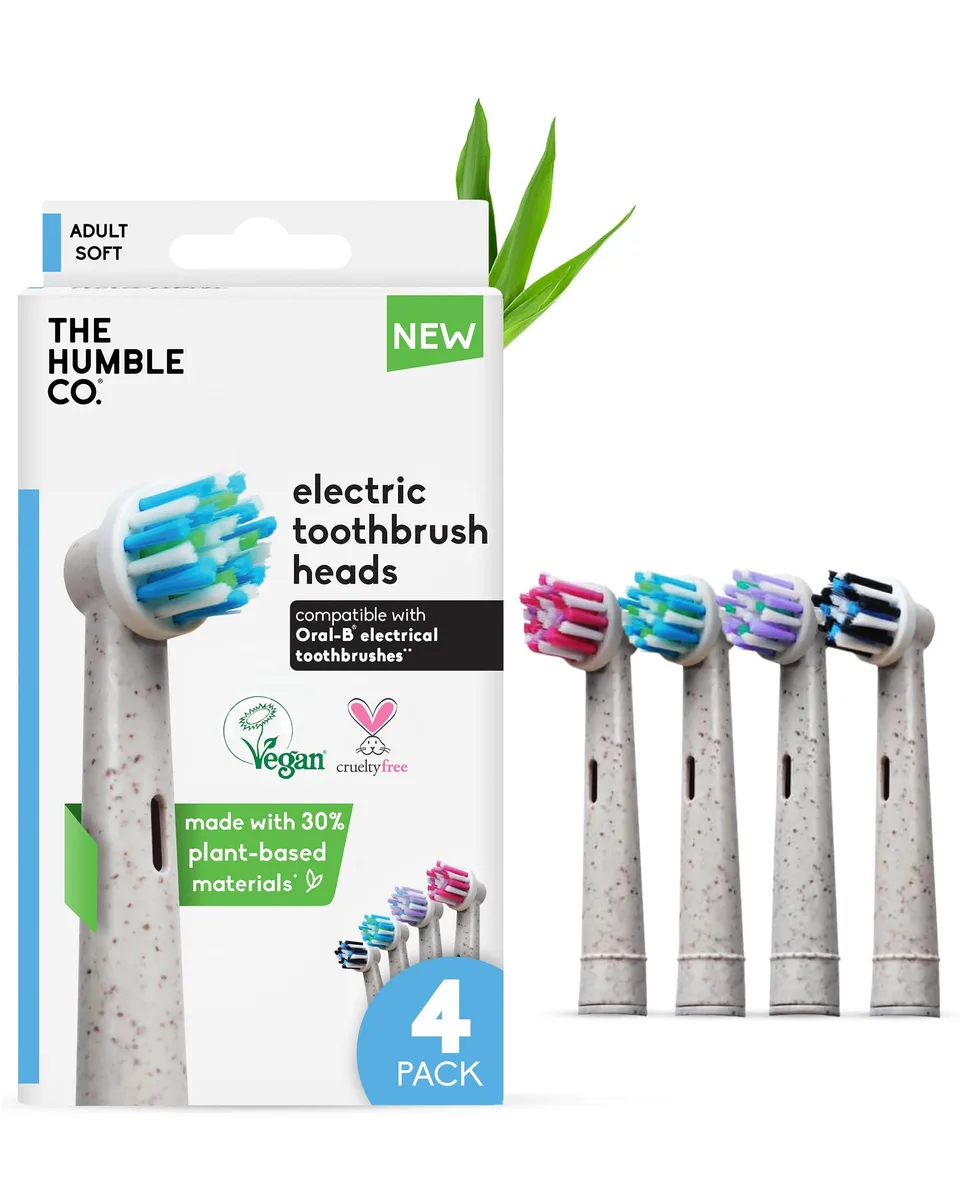 Four white bamboo-composite toothbrush heads with soft bristles in a pack