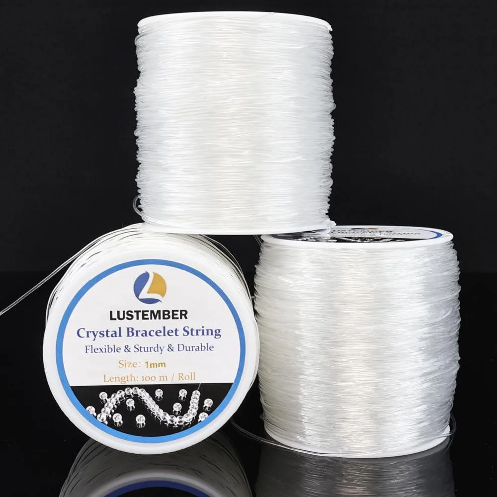 Three spools of clear 1 mm elastic cord on a light surface