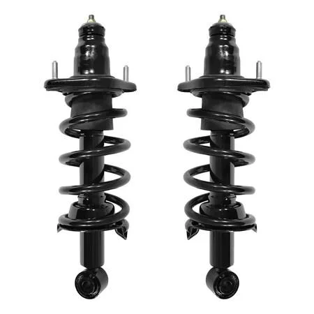 Two silver rear strut assemblies with coil springs and top mounts