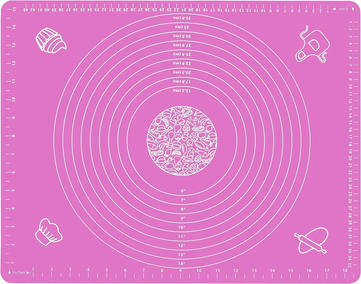 Pink rectangular silicone counter mat with printed measurement scales, 20 by 16 inches