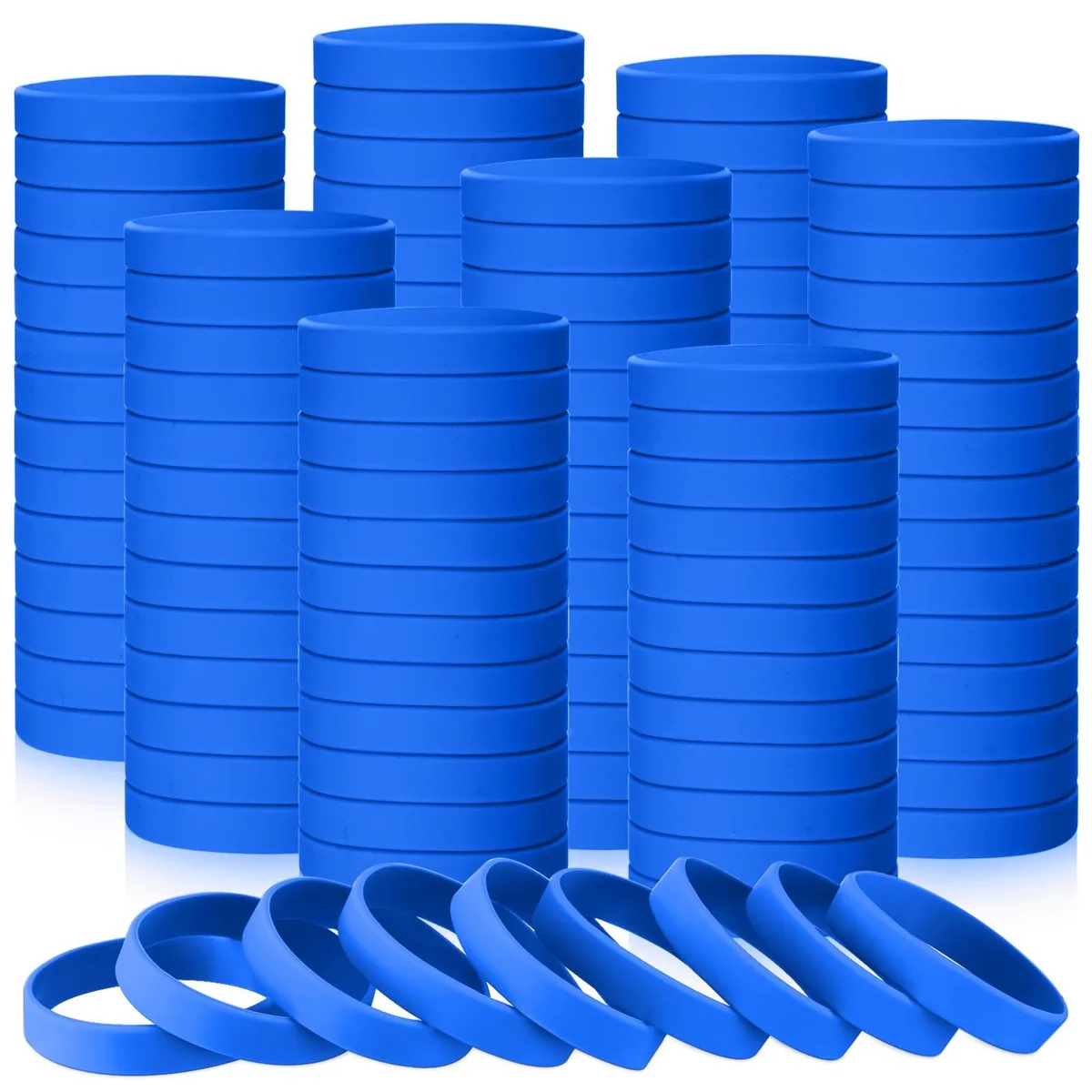 Fifty blue silicone wristbands laid flat, each a smooth flexible loop about eight inches long and half an inch wide
