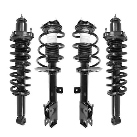 Four silver strut assemblies with black coil springs on grey background