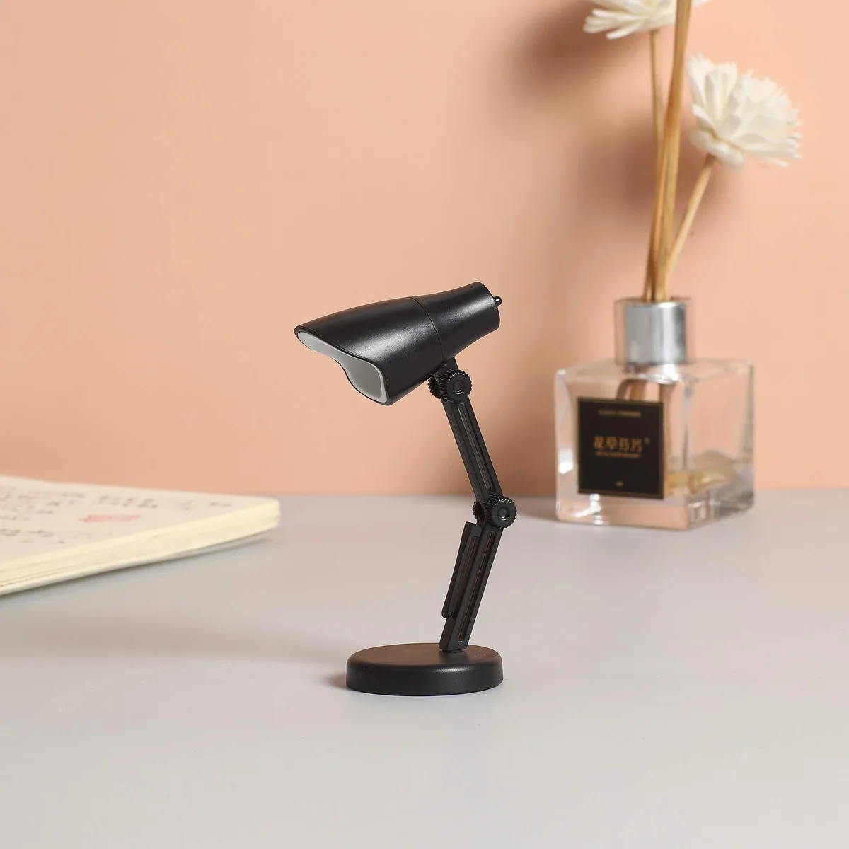 Two small black clip-on book lights with flexible necks and magnetic bases