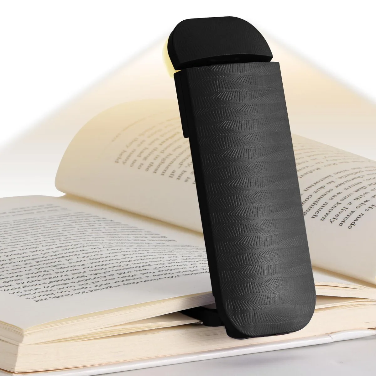 A compact black clip-on book light with an arched lampshade and electroplated metal clip