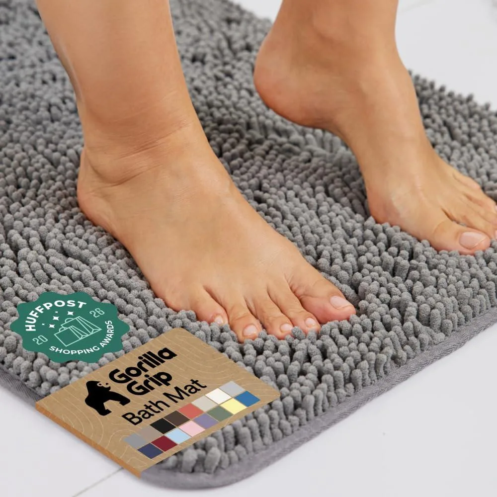 Grey rectangular bath rug with plush chenille surface and rubber backing, 30 by 20 inches