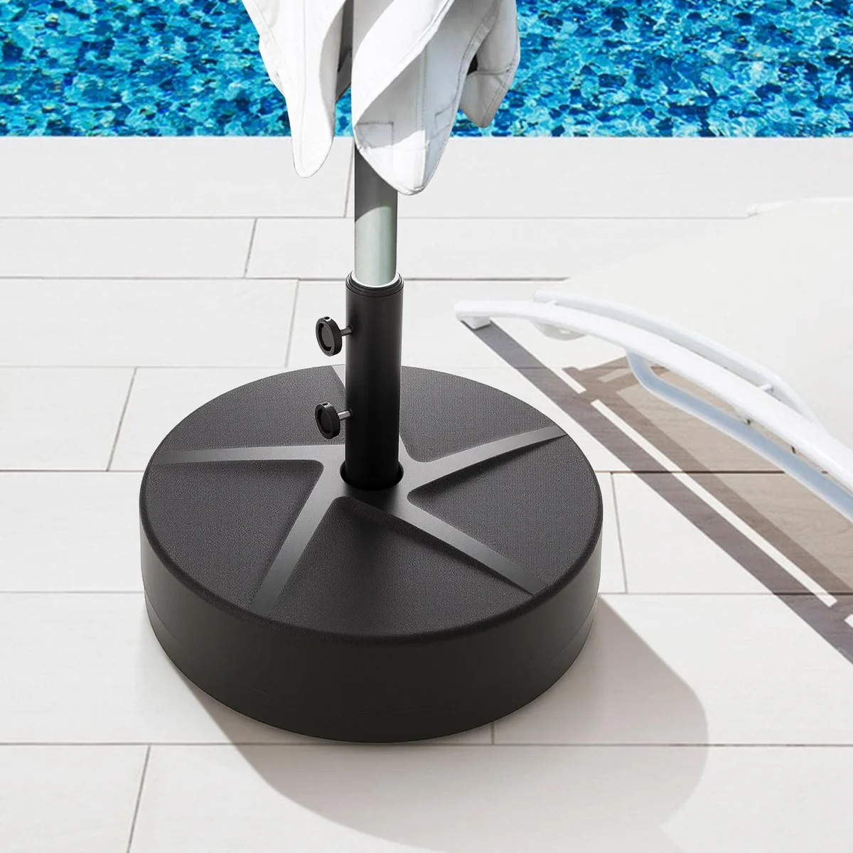 Black round patio umbrella base with grey accents and three adapters visible on top