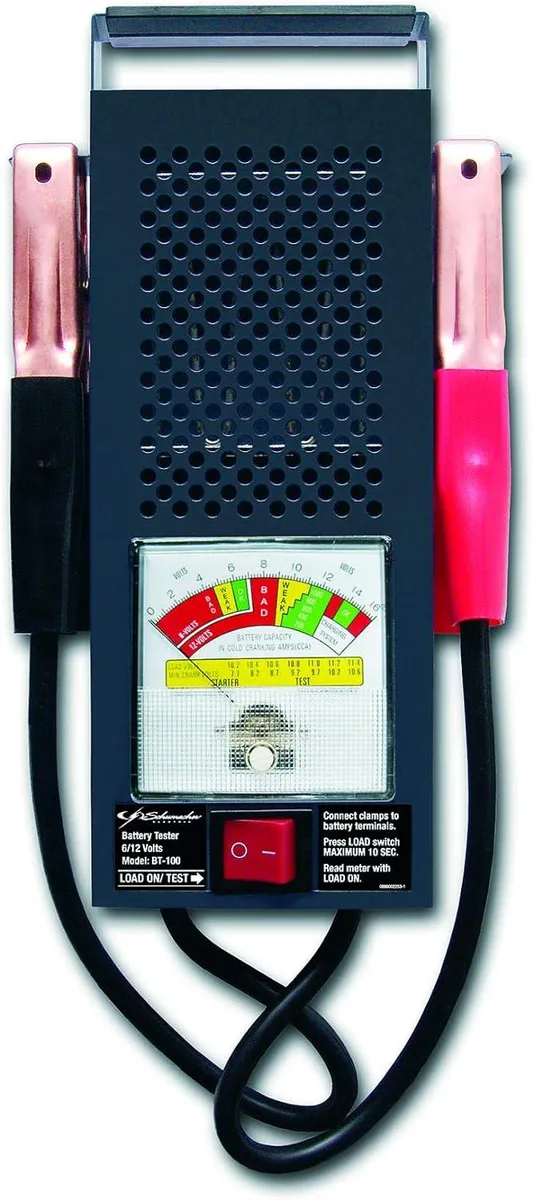 Black steel-cased battery load tester with rubber handle, analog meter, rocker switch and heavy-duty colour-coded clamps
