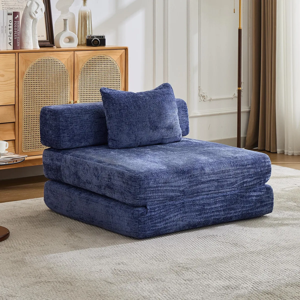 Dark blue chenille floor sofa bed, modular single seater, folded with side armrests visible