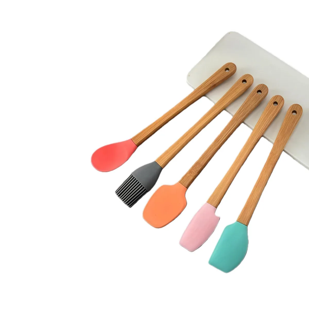 Five colourful mini silicone utensils with bamboo handles and a steel ring