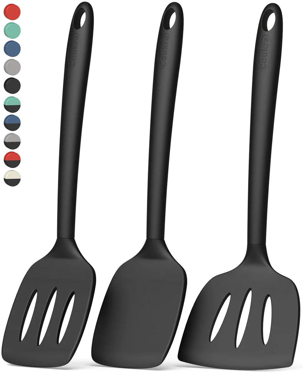 Three black silicone spatulas on a white background, rectangular heads, slim handles, hanging holes