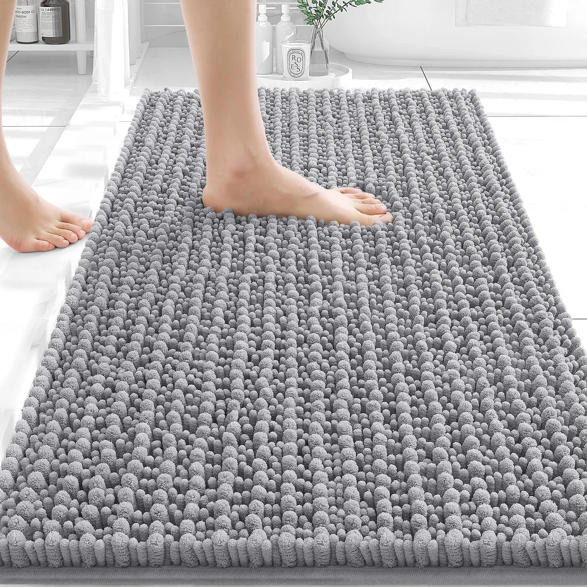 Rectangular grey chenille bath mat with plush high-low pile and rubber backing
