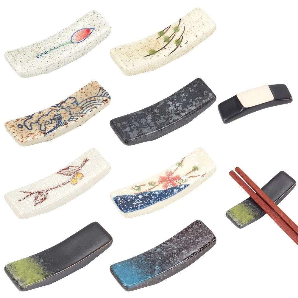 Eight black ceramic chopstick rests with varied Japanese patterns in a clear case