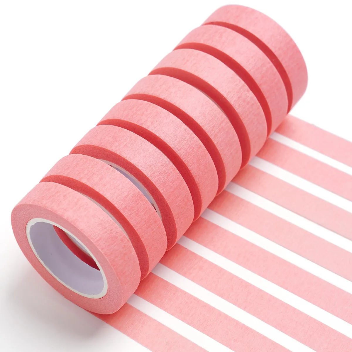 Eight small pink masking tape rolls in a row