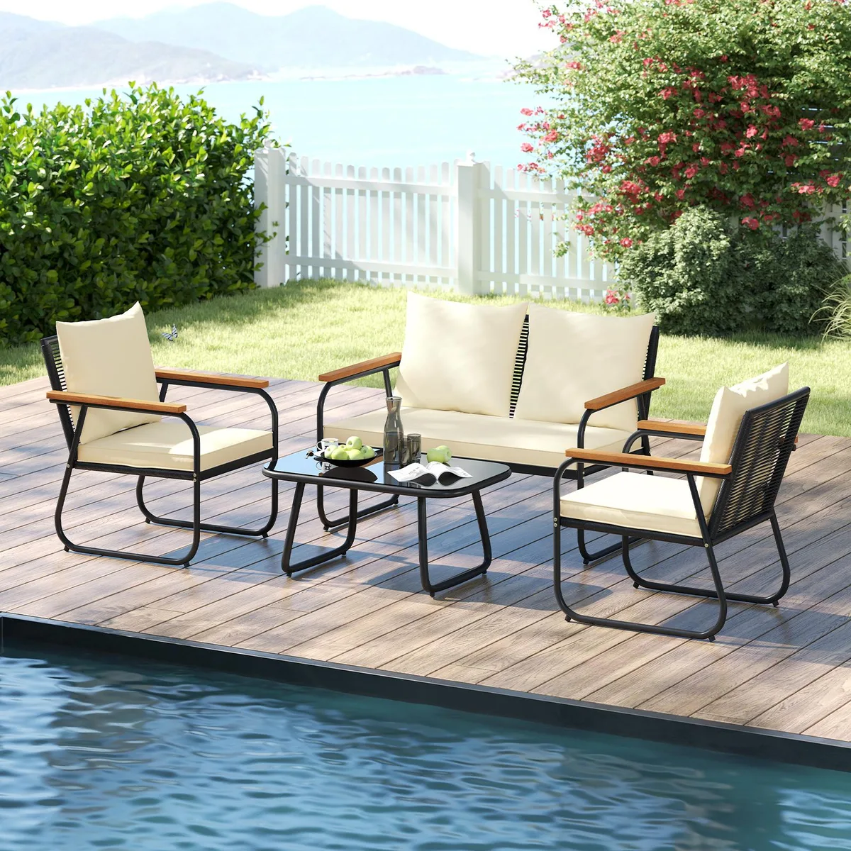 Black PE rattan four-piece patio set with tempered glass coffee table and off-white cushions