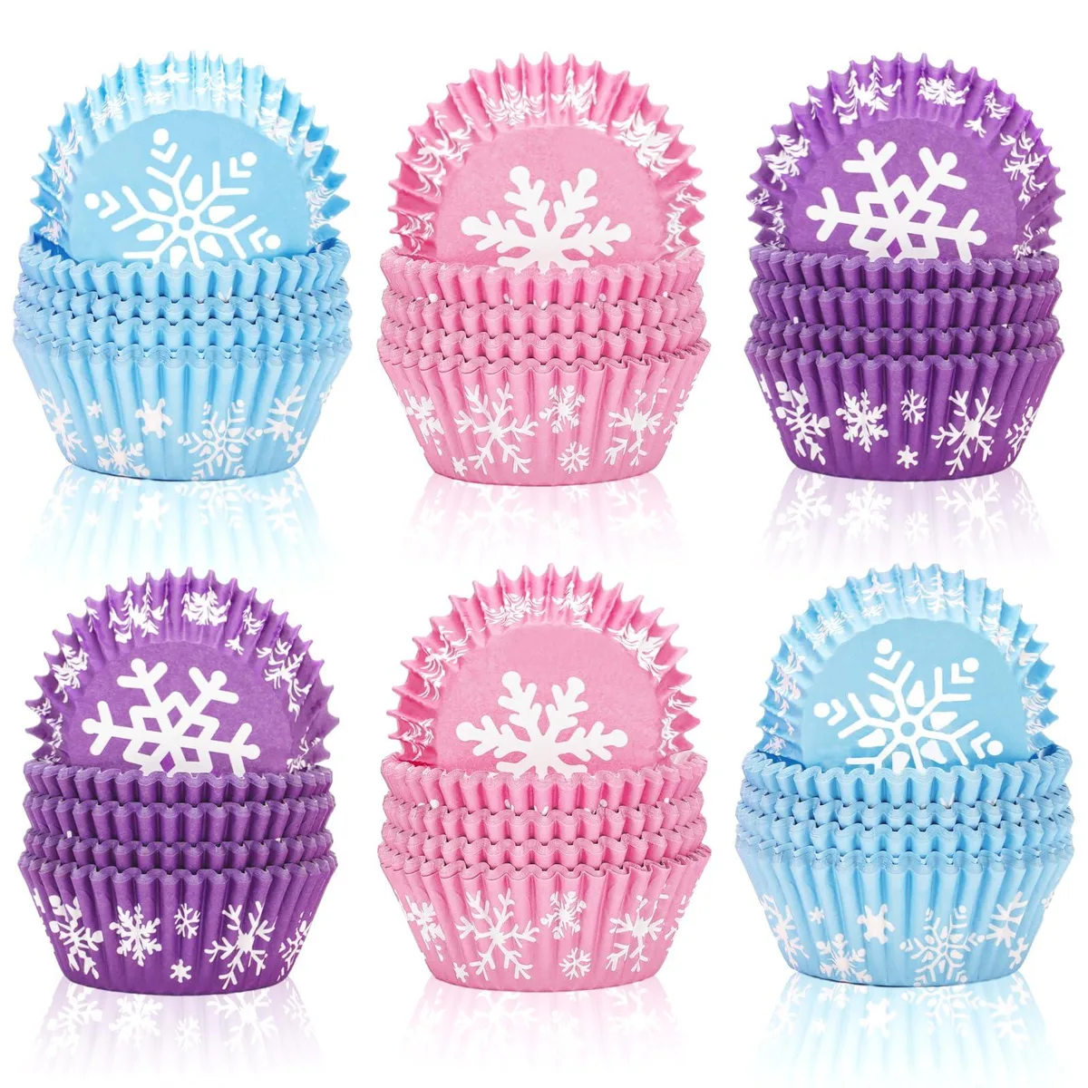 Stack of paper cupcake liners in pink, blue and purple with snowflake pattern