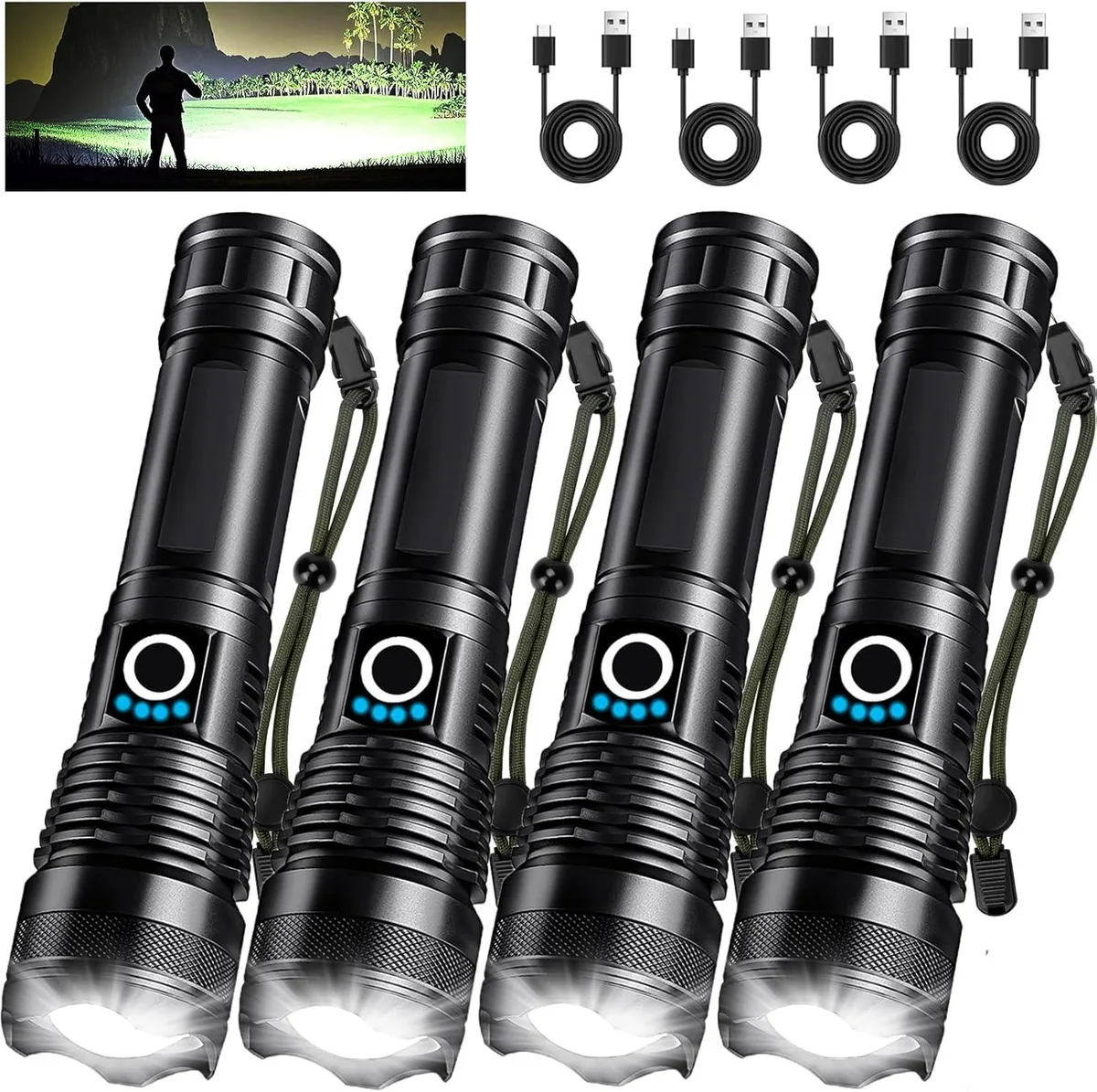 Four black cylindrical flashlights with USB cables lying on a light surface