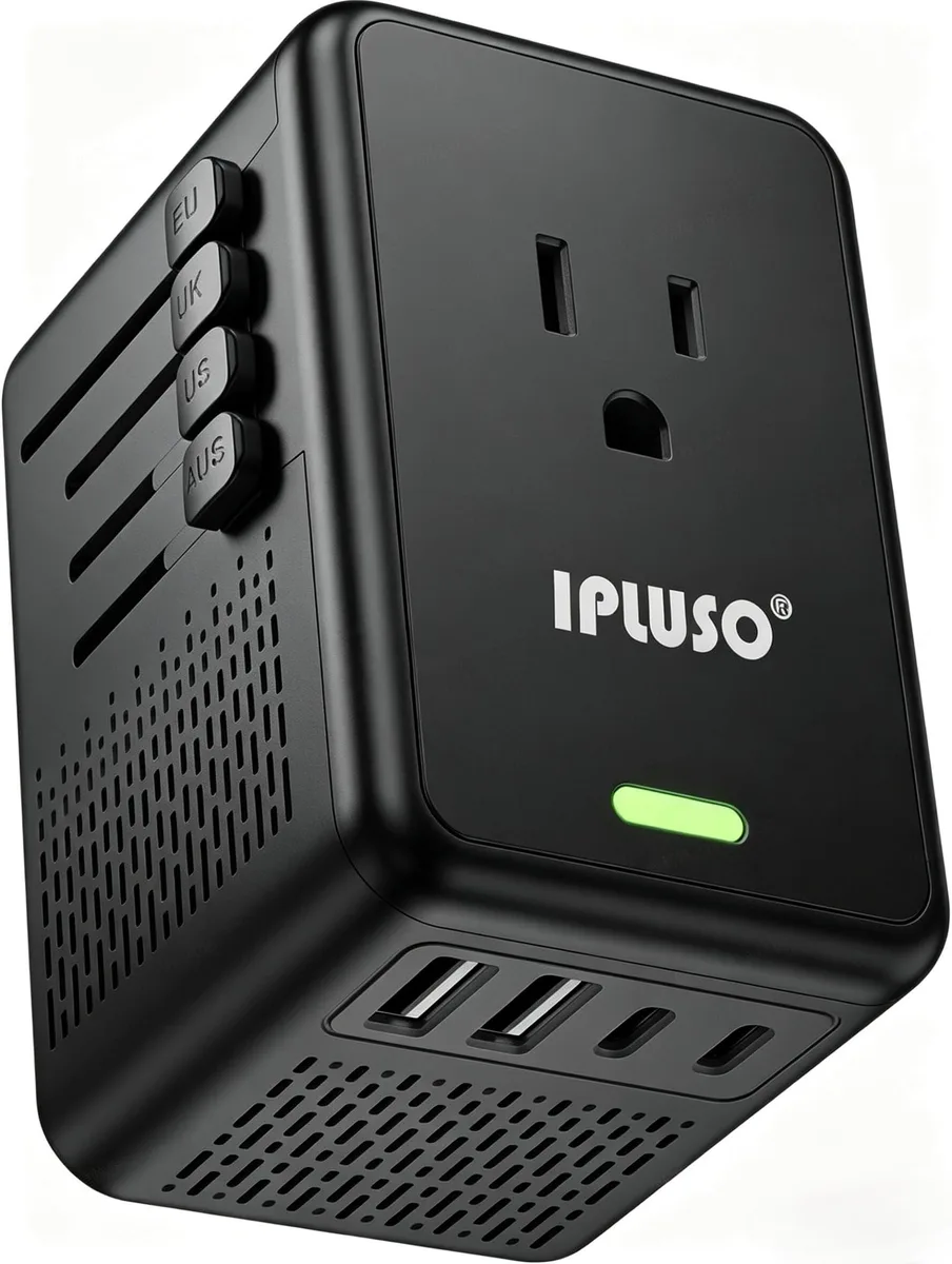Black rectangular voltage converter with interchangeable plugs, one AC outlet, two USB-A and two USB-C ports