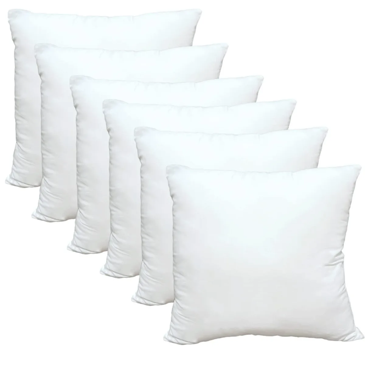 Six square white polyester pillow inserts on a grey mat