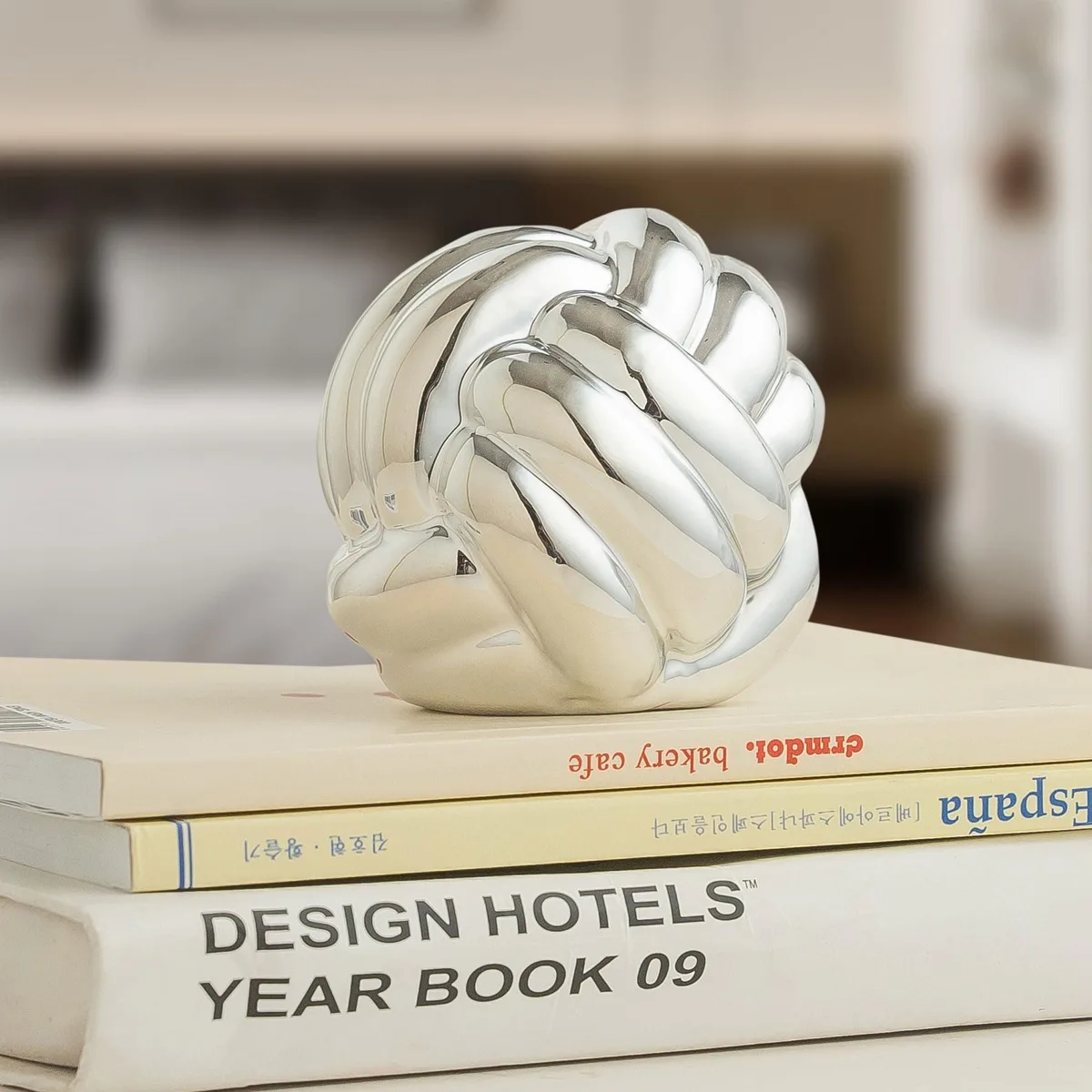 Forty-eight small silver ceramic knot balls in a pack