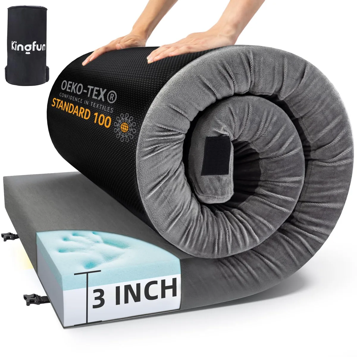 Gray rectangular foam mattress rolled inside a dark travel bag with side zip pockets