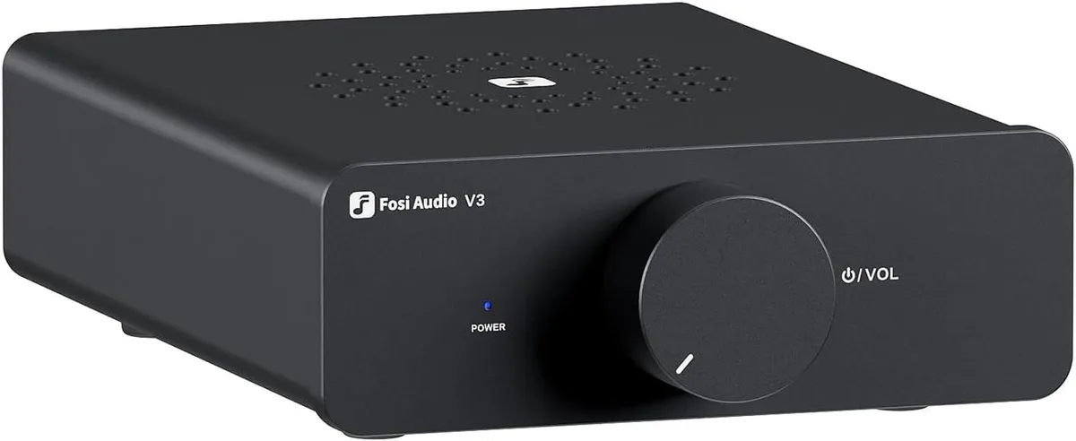 Compact silver box with vented top and bottom, front knob and rear speaker terminals