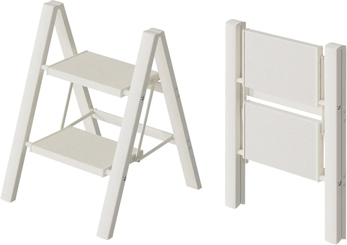 White two-step aluminium ladder with wide ridged steps and rubber feet, folded to 1.8 inches thick