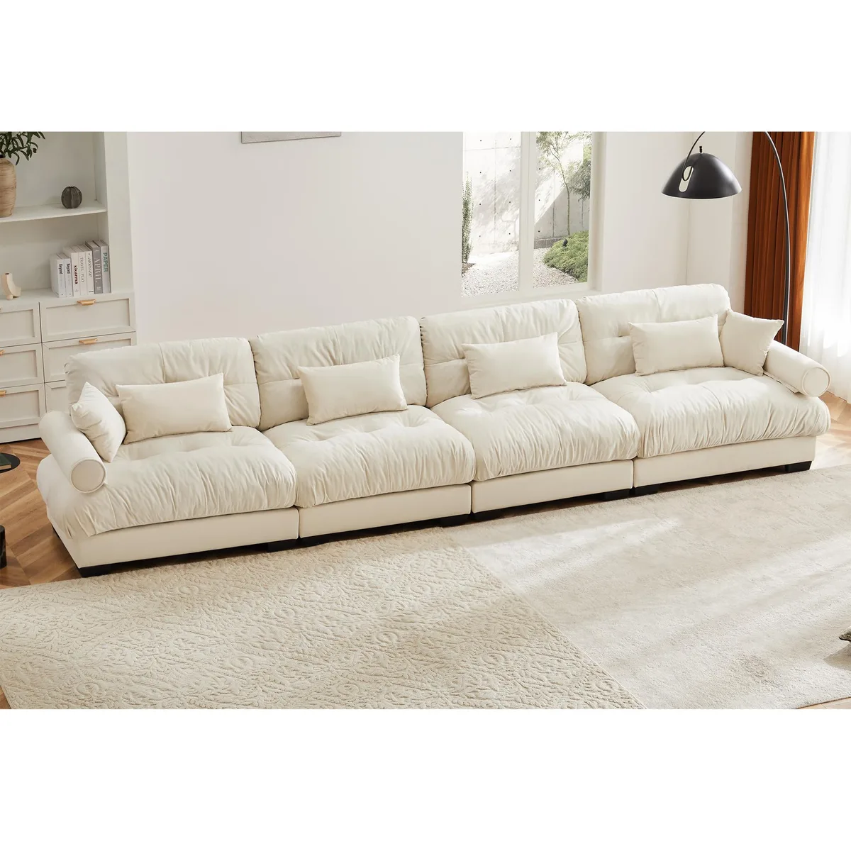 Cream velvet modular sectional sofa with movable ottoman and bolstered armrests