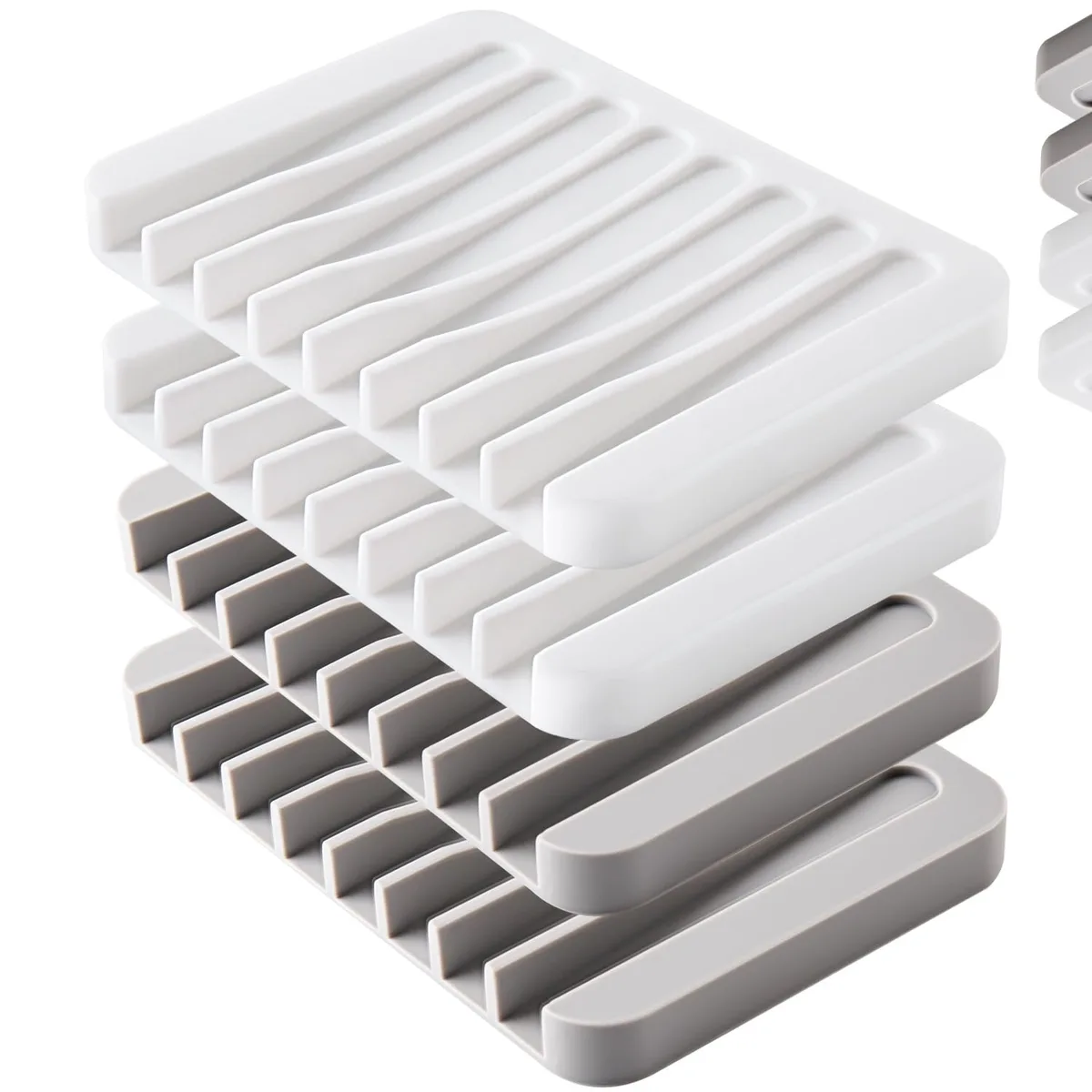 Four white and grey silicone soap dishes with grooved self-draining surface