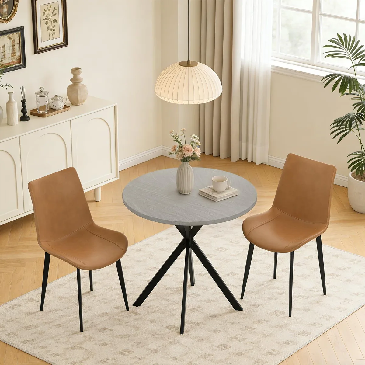 31.5 inch round gray table with two beige upholstered chairs and X-shaped metal legs
