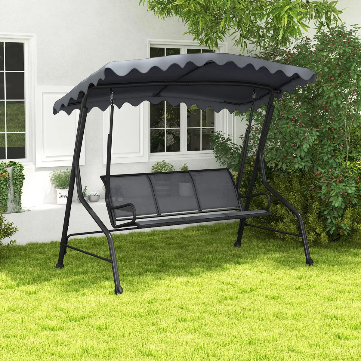 Grey three-seat porch swing with metal frame, adjustable canopy and anti-slip footpads