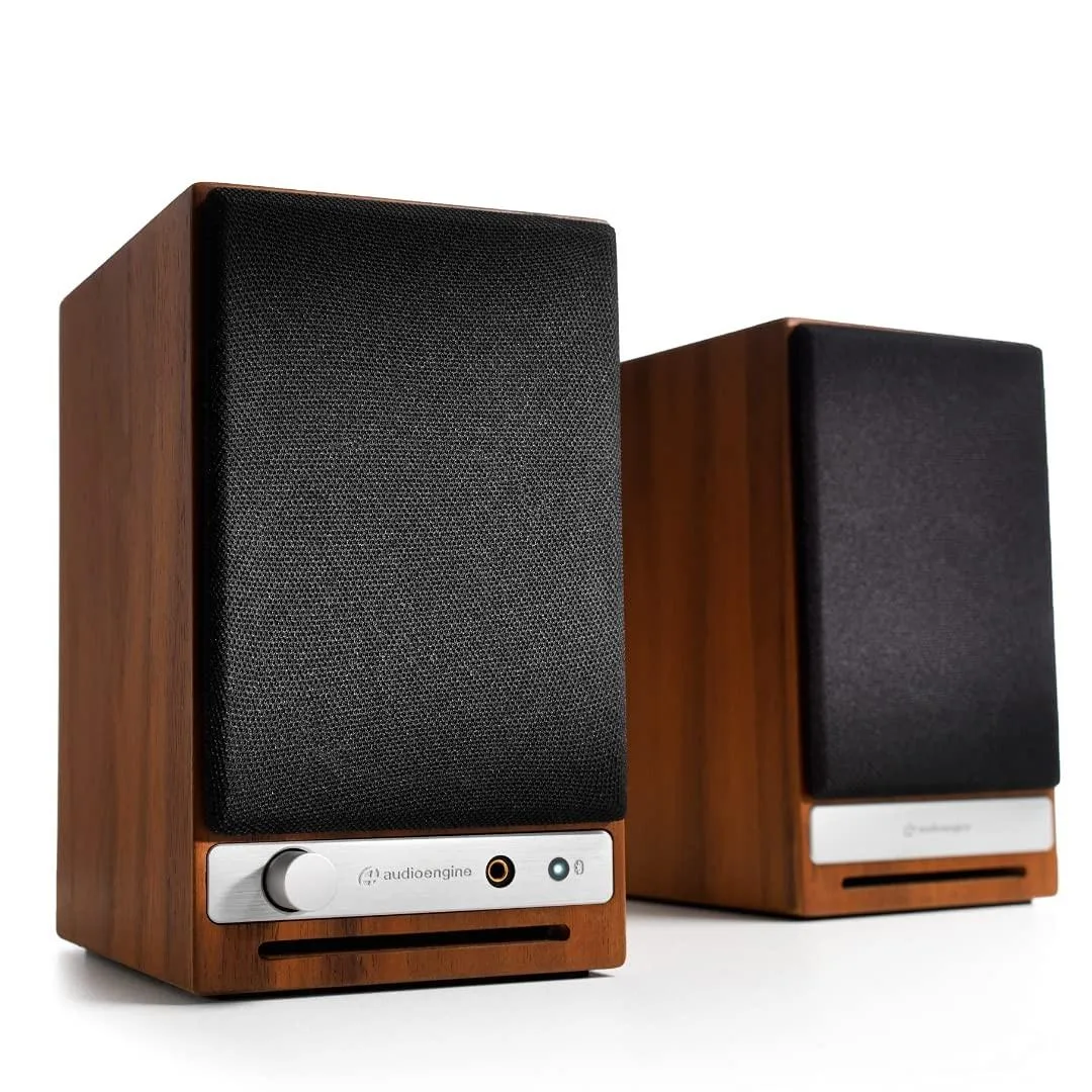 Pair of compact desktop speakers with matte finish, front volume knob and headphone jack