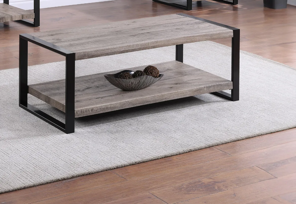 Rectangular wooden coffee table with rustic brown-grey finish and lower storage shelf, double pedestal base