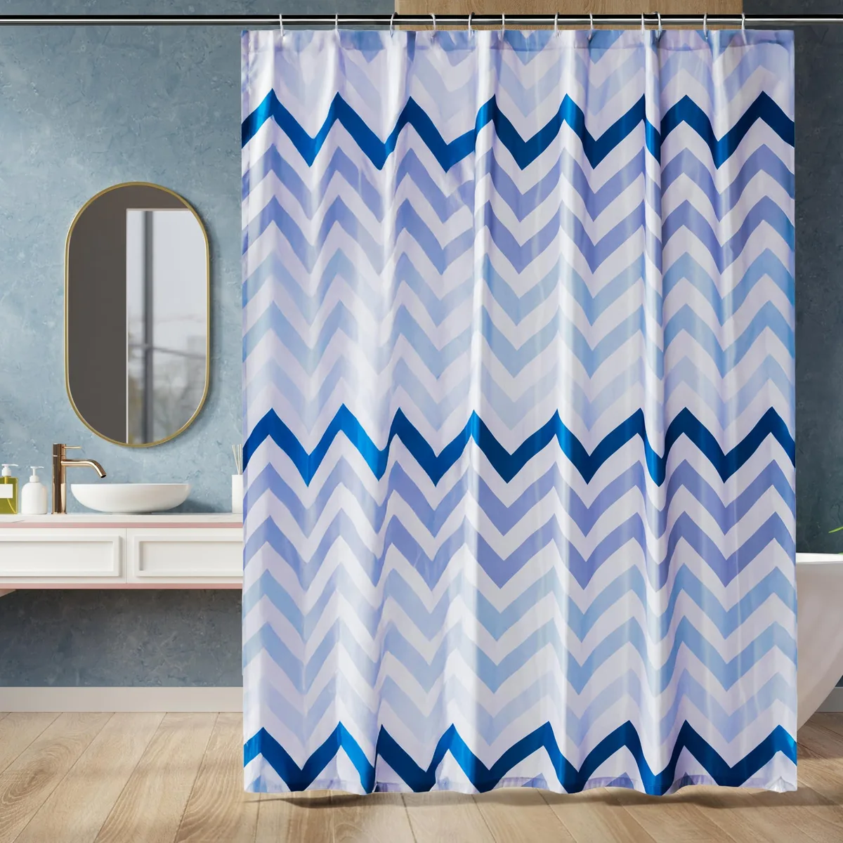 Rectangular polyester shower curtain, blue ombre chevron pattern, weighted hem, 12 white hooks included