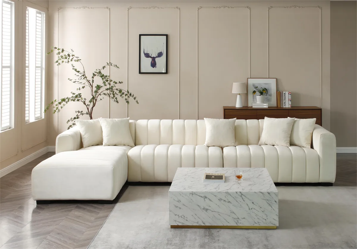 Large beige velvet modular sofa with channel tufting and left chaise