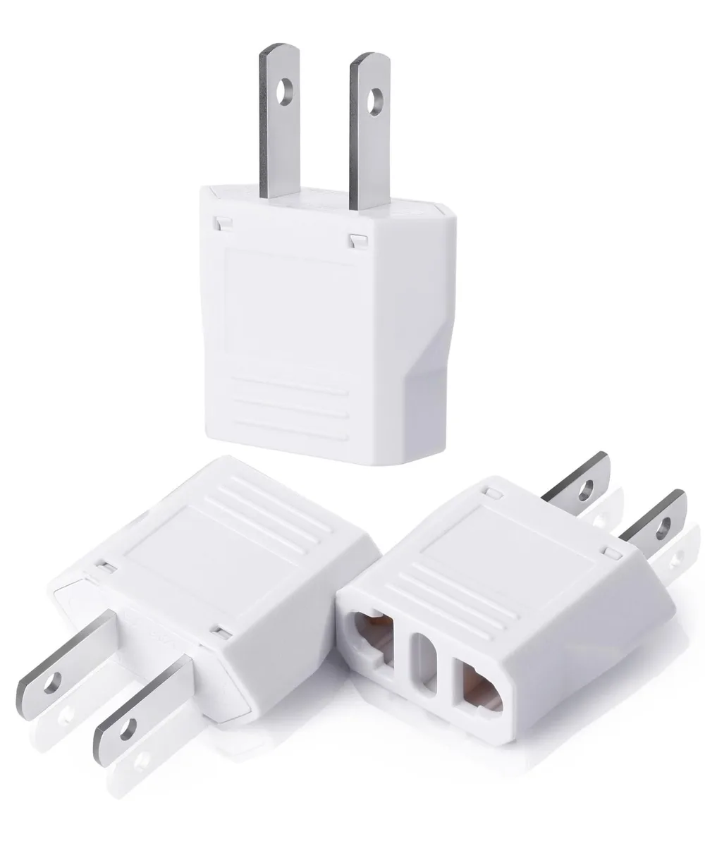 Three small white EU-to-US plug adapters on a plain background