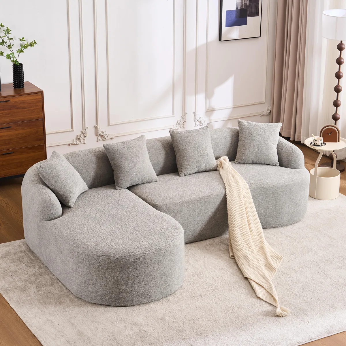 Light grey L-shape sectional with curved chaise and plush cushions