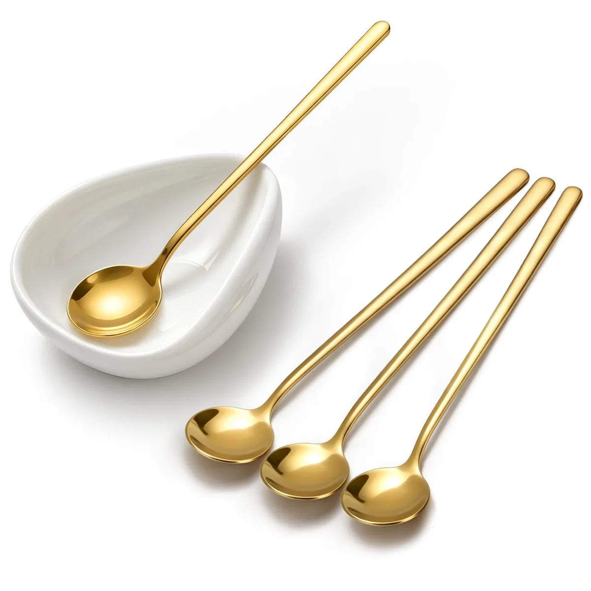 Four gold spoons and a white ceramic spoon rest