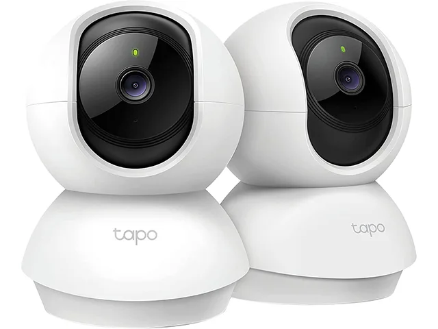 Two white pan-tilt cameras on a surface, compact rounded bodies with front lenses