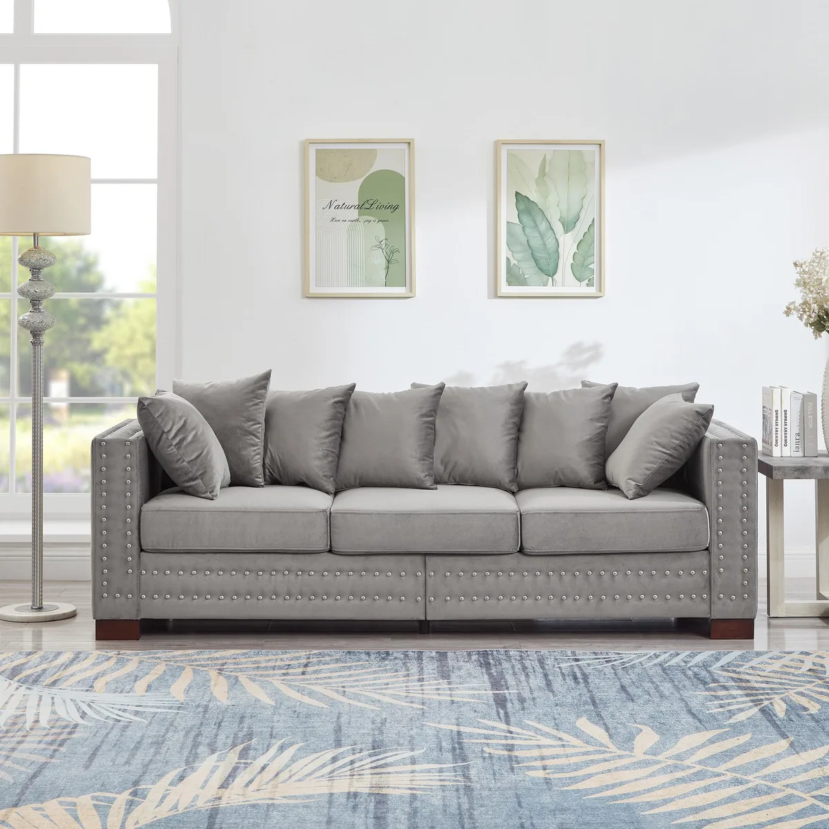 Grey velvet sofa with square arms and silver nail trim