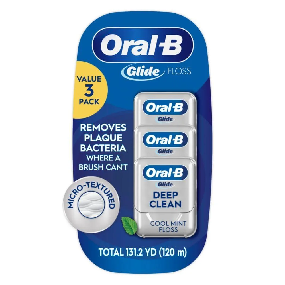 Three white floss dispensers in a cardboard box