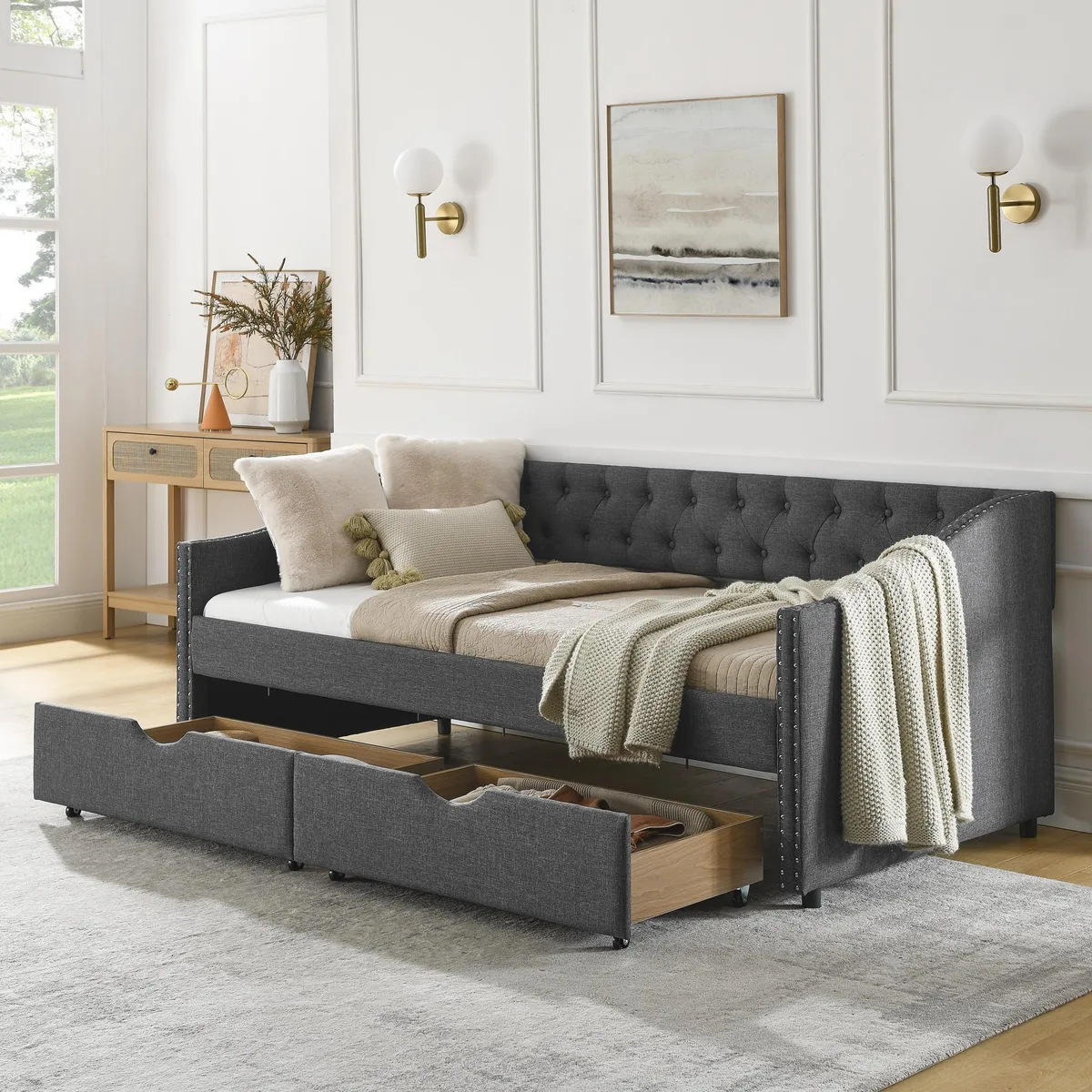 Dark grey linen daybed with tufted back, copper nailhead arms and two drawers