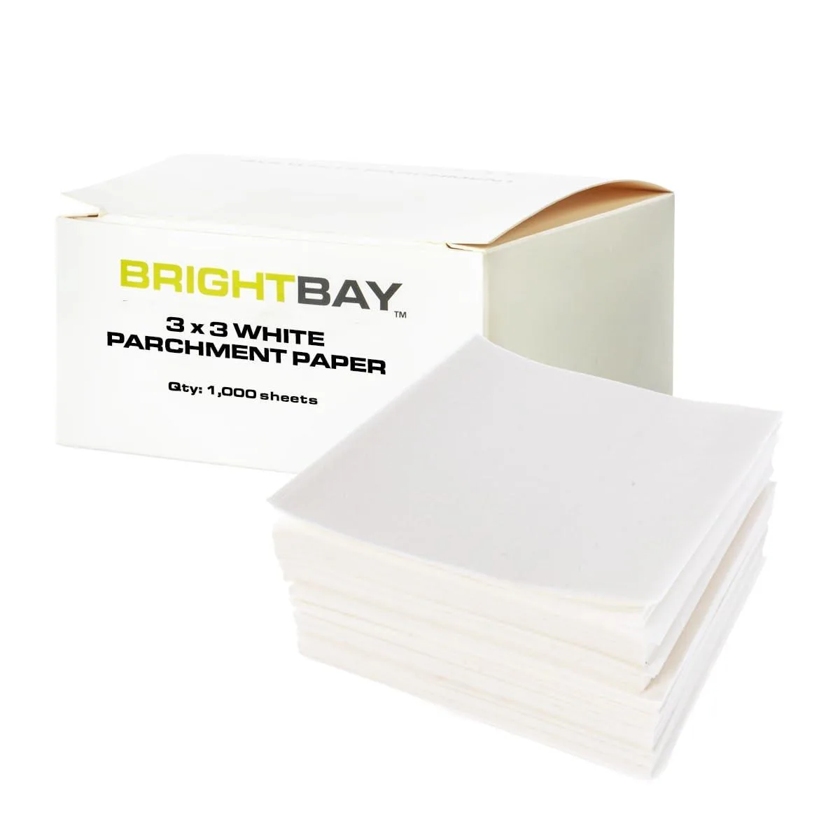 Stack of white parchment paper squares in a box