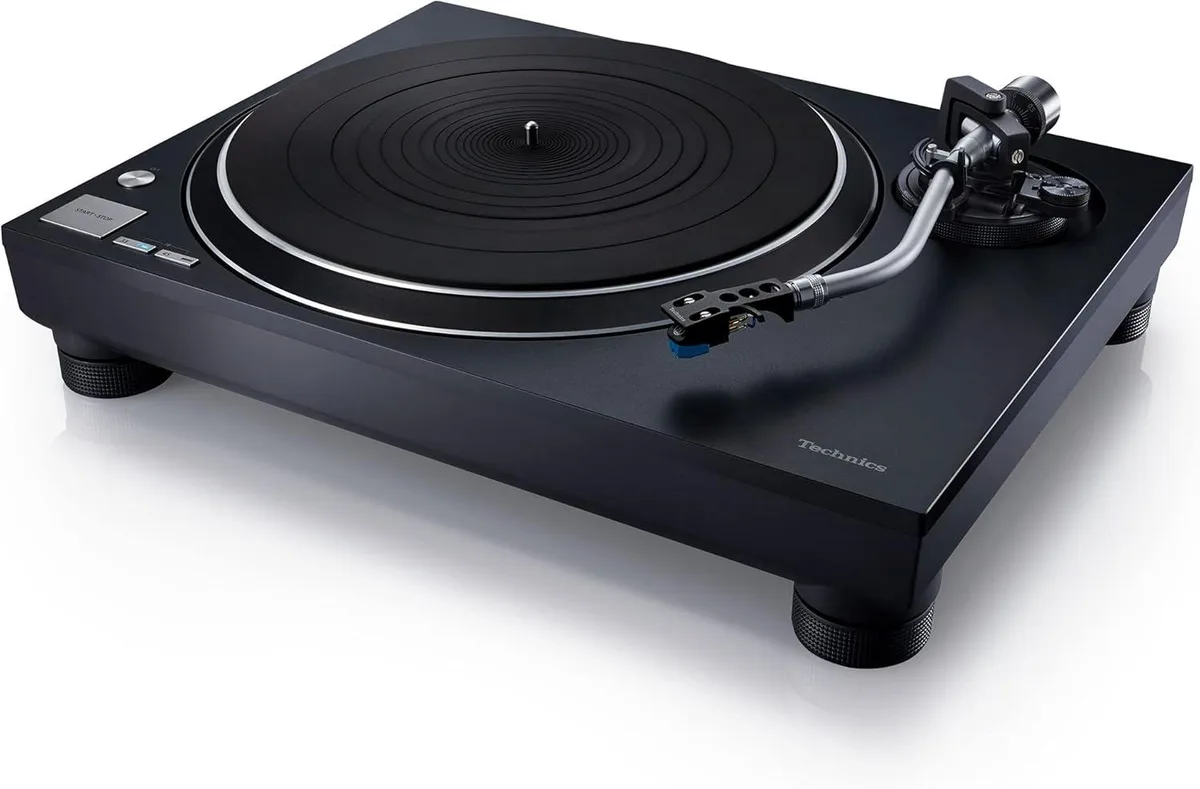Silver direct-drive turntable with S-shaped tonearm, dust cover, and pre-mounted cartridge
