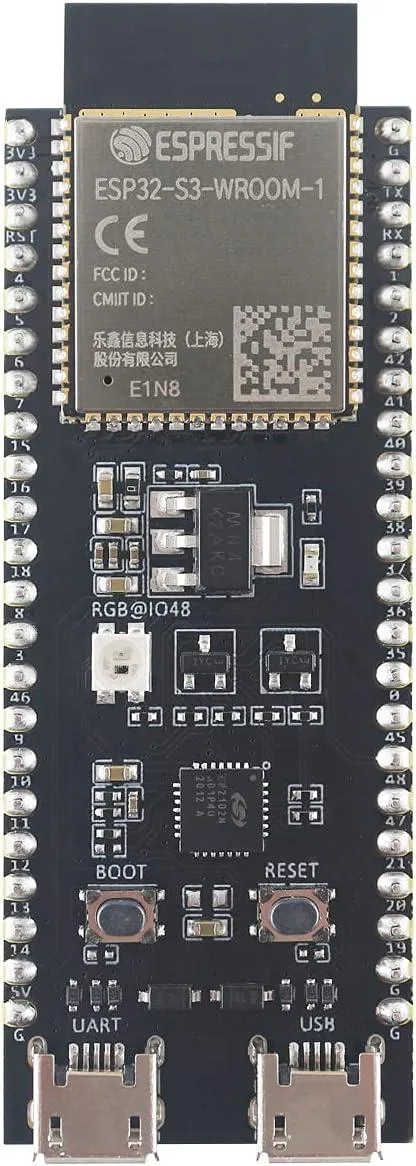 Green rectangular development board with ESP32-S3 module and pin headers