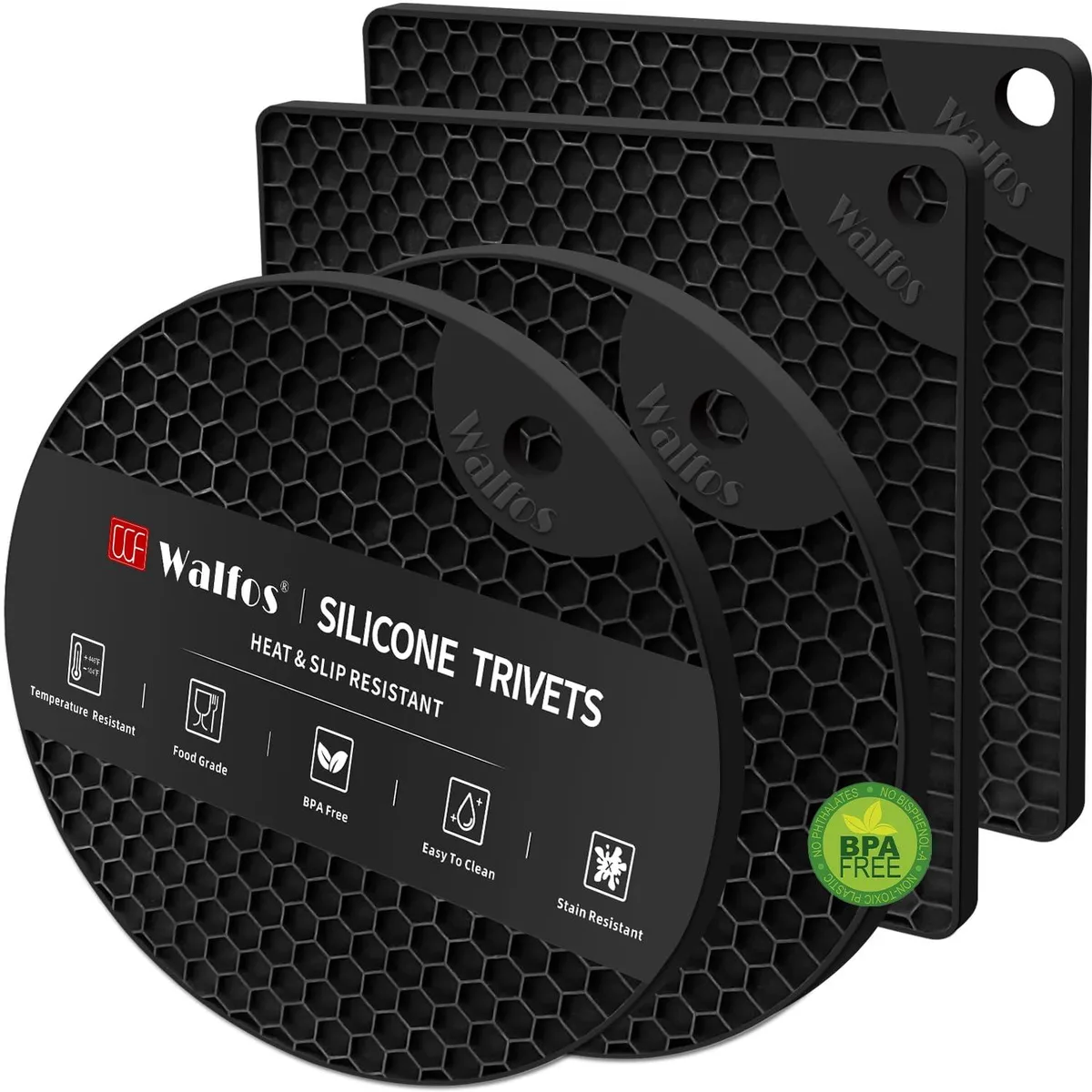 Four black silicone trivet mats, two square and two round, textured non-slip surface
