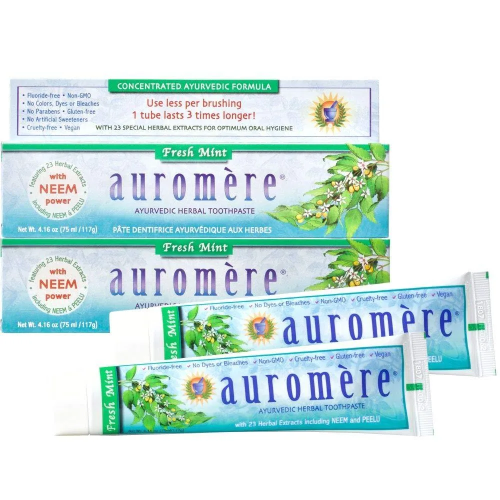 Two white tubes of Ayurvedic toothpaste with mint-green caps