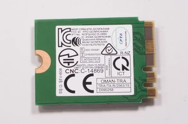 Small rectangular green circuit board with gold edge connector and two tiny antenna sockets