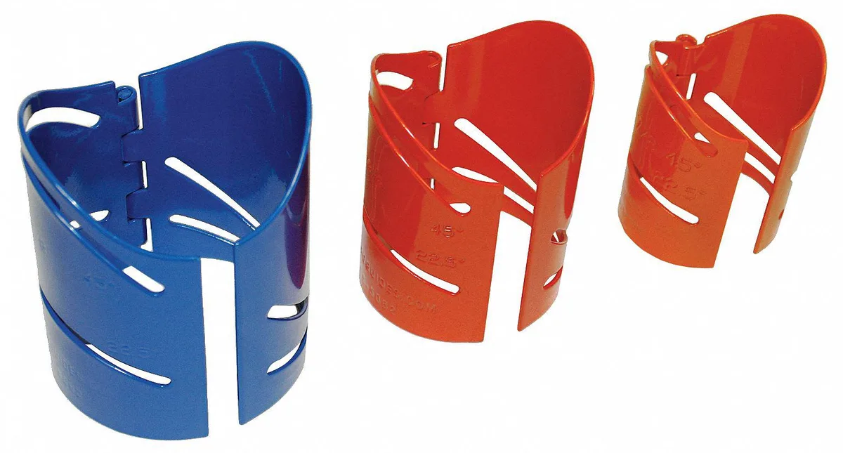 Three magnetic metal cutting guides with angled templates on dark surface