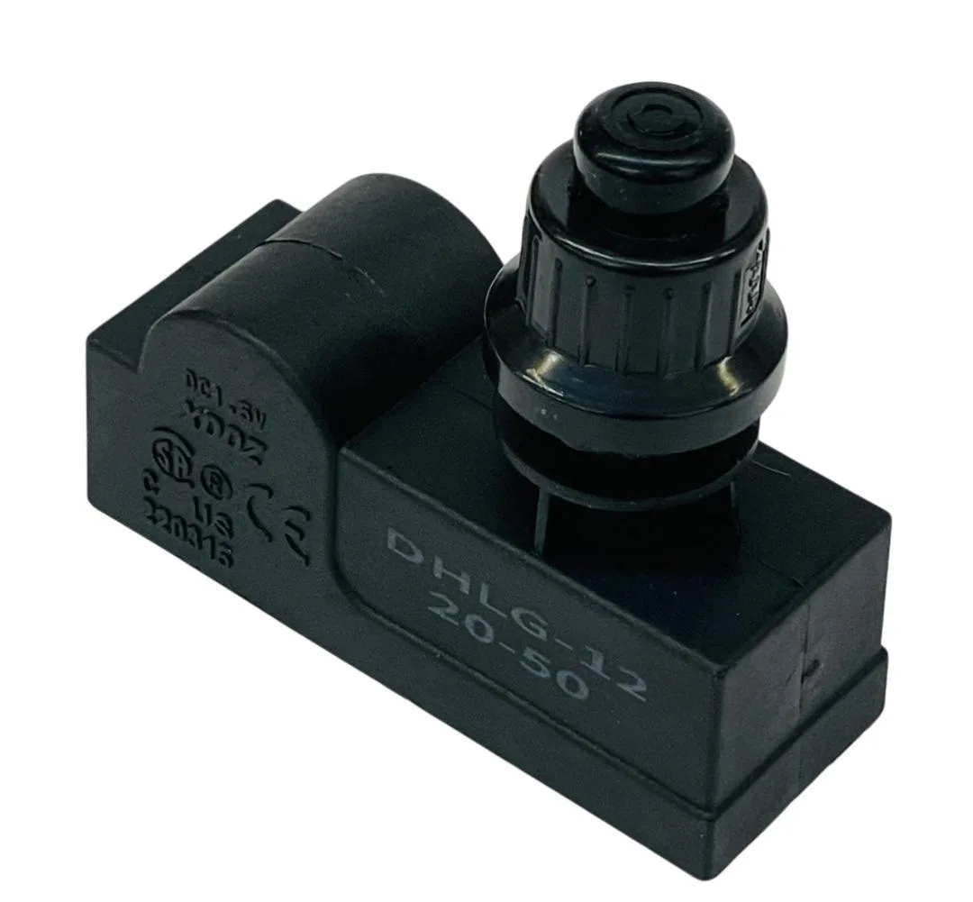 Small black rectangular ignition module with two wire terminals and a push-button cap
