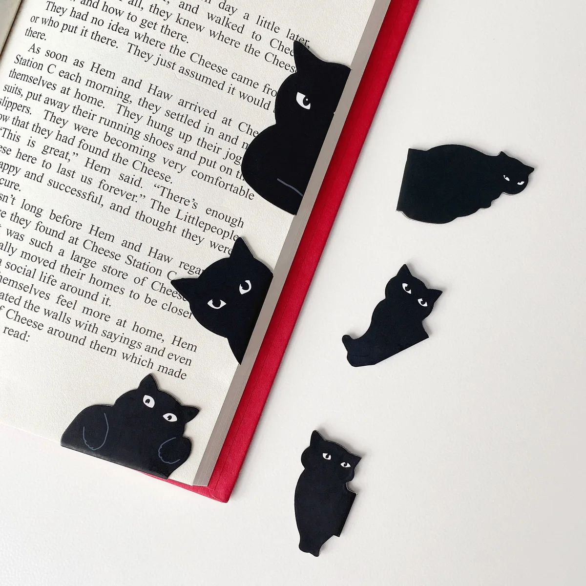 Six black paper magnetic bookmarks in assorted cat designs